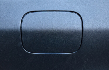 Black car fuel door design with smooth finish and subtle contours