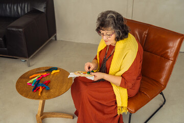 Senior enthusiast engaging in creative crafting in a cozy indoor space
