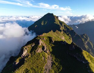 High-angle view of a mountain ridge piercing through a cloud layer