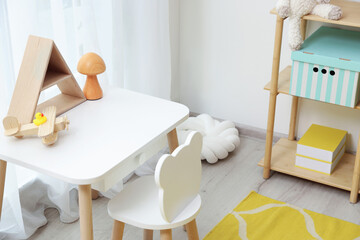 Stylish playroom with toys, decor and furniture. Interior design