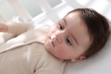 Bedtime. Cute little baby in crib at home
