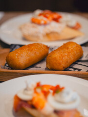 Golden croquettes and colorful pintxos served in a traditional eatery in San Sebastián,...