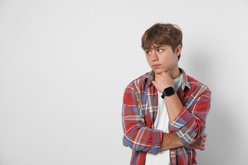 Cute teenage boy on light grey background. Space for text