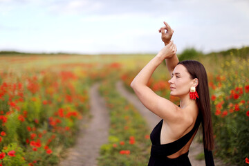 Beautiful woman posing in wildflower meadow. Space for text