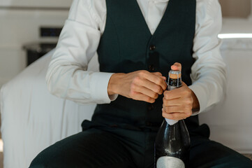 Opening a bottle of sparkling wine in a stylish setting