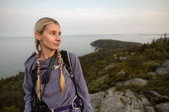 woman hiker with pigtails at summit of mountain, Acadia National Park