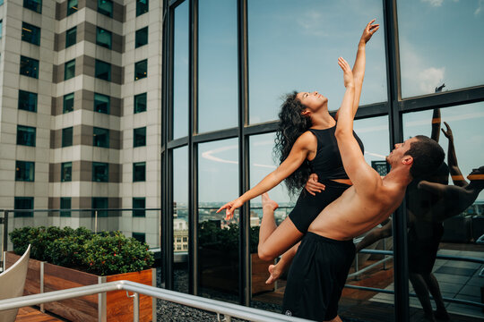 Dancers reach skyward in expressive rooftop lift in Boston