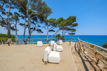 Modern White Outdoor Furniture On Mediterranean Coastal Terrace With Sea View. Pine Trees, Blue...