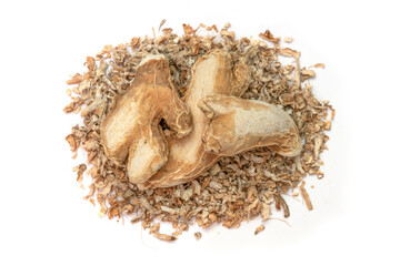 Whole dried ginger root and crushed pieces, an aromatic herbal spice on white background.