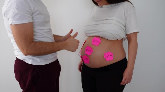 Father removes sticky notes with boy names from pregnant belly revealing it&rsquo;s a girl