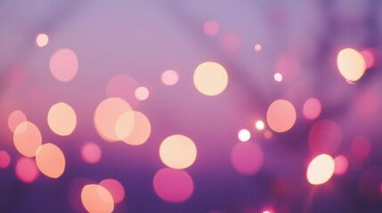 Abstract blurred background with pink and orange bokeh lights.