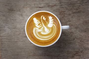  a cup of latte art coffee on wooden background                                                                                                                                                         