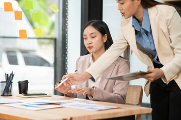 Fototapeta premium Asian business woman working and talking at the office 