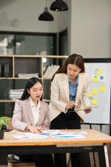 Asian business woman working and talking at the office	