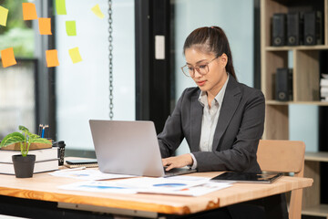 Asian businesswoman working on laptop at office