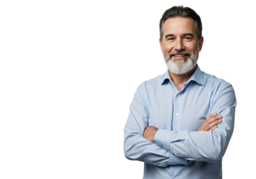 A middle-aged caucasian man (45-55) with short dark hair, grey temples, and a trimmed grey-white beard, wearing a light blue button-up shirt, arms crossed, smiling confidently at camera against a