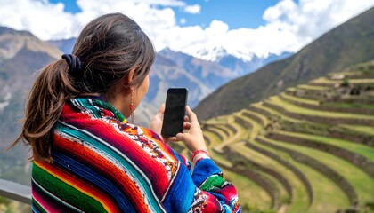 Woman taking photo of Andes terraced fields