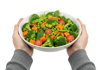 A healthy bowl of fresh vegetables including broccoli, peas, carrots, and tomatoes, held by hands isolated on transparent background