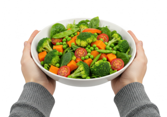A healthy bowl of fresh vegetables including broccoli, peas, carrots, and tomatoes, held by hands isolated on transparent background
