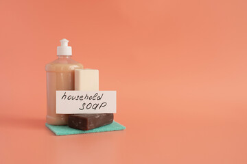 Pieces of dark and light soap and liquid soap in close-up on a light background of kopi space