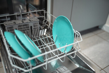 Loading dishwaher. Daily chores concept.