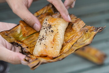 Grilled Thai sticky rice: a sweet, savory, banana leaf delight.