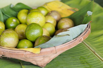 Fresh Green Limes Abundantly Fill Woven Basket.