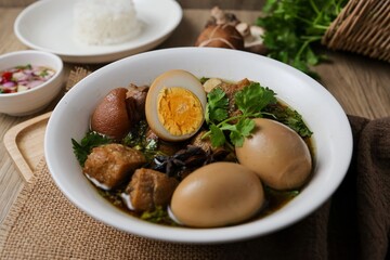 Seasoned eggs, hard boiled eggs and pork belly in Chinese Five Spices Sauce,Five Spice Egg with pork, thai called kai pa lo, boiled eggs and pork in brown soup