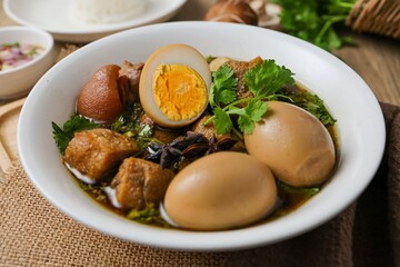 Seasoned eggs, hard boiled eggs and pork belly in Chinese Five Spices Sauce,Five Spice Egg with pork, thai called kai pa lo, boiled eggs and pork in brown soup