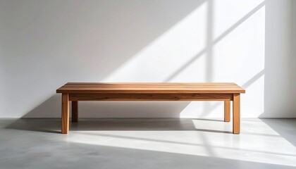 Clean-line oak bench with no visible joints, placed against white textured wall with concrete flooring and soft daylight shadows