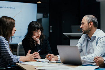 Business executives discussing startup investment losses in boardroom meeting
