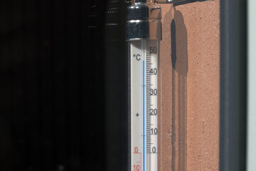 Thermometer on outside of a house