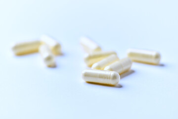 Alpha-lipoic acid capsules. Paper background. Soft focus. Close up. Copy space.	