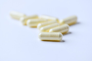 Alpha-lipoic acid capsules. Paper background. Soft focus. Close up. Copy space.	