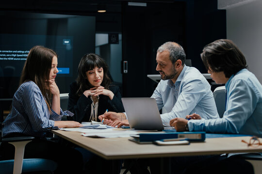 Modern office team meeting with presentation screen and professional executives brainstorming