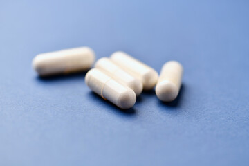 Arginine capsules on bright background. Soft focus. Close up. Copy space.	