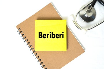 Beriberi writing on a sticky note on a book. medical and health concepts.
