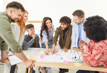 Group of business people working together on documents during a meeting in the office. The team...