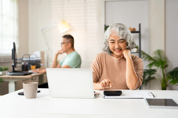 Senior woman finance and investment or paying their bills at home. Married man and woman use...