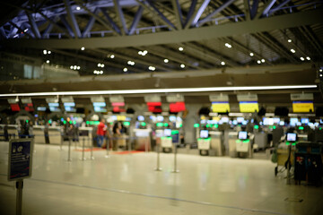 Airport ticket machines and check-in counters (blurred background, defocused)