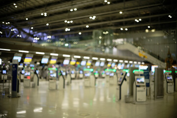 Airport ticket machines and check-in counters (blurred background, defocused)