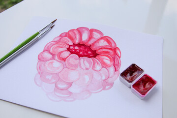 Watercolor raspberry painting in progress with brushes and red pans – close-up of fruity...