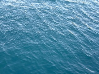Blue water rippling calm surface background.