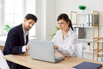 Young concentrated serious business people company employees man and woman having meeting at...