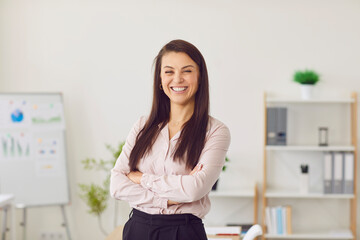 Portrait of happy smiling confident young woman company employee wearing formal clothes looking...