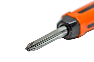 Closeup of an orange screwdriver tip and handle on black background