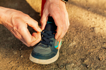 A man repairs children's sneakers. Close-up of hands and sneakers. Shoemaker. Jack of all trades....