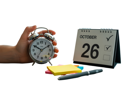 A fair skinned hand gently holding a silver alarm clock showing the time against a black background with an October 26th desk calendar and... isolated on a transparent background - Powered by Adobe