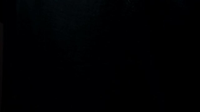 Finger snap.
A man's hand makes a snap of his fingers on a black isolated background.
Gestures with hands and fingers.
Rhythm with fingers