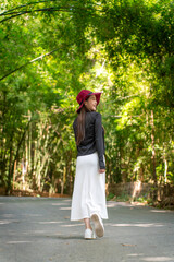 Asian woman exploring Wat Pha Lat temple in Chiang Mai. Young tourist enjoying serene travel moments at historic jungle temple in Northern Thailand.